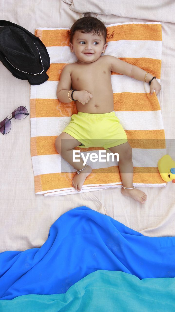 PORTRAIT OF BOY IN A BED