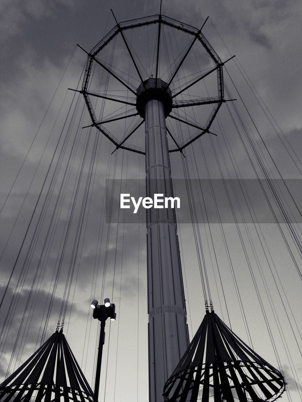 Low angle view of amusement park ride against sky during dusk