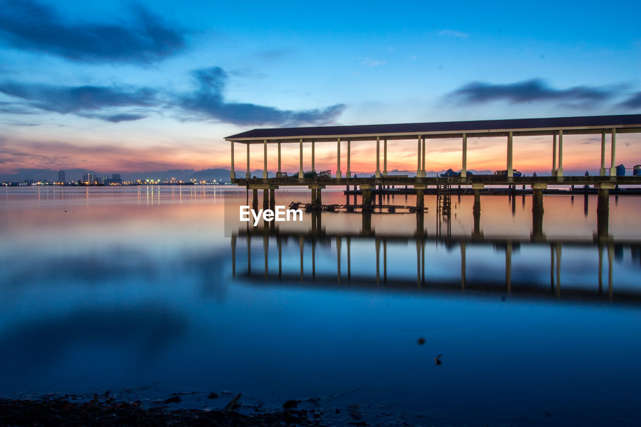 Scenic view of lake against sky at sunset