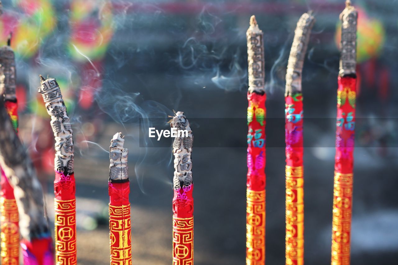 Close-up of multi colored incense in temple