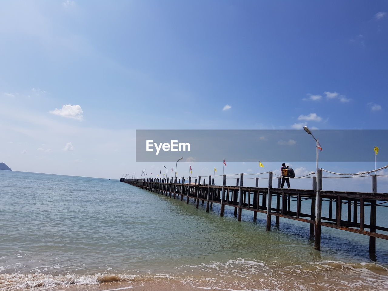 PIER AMIDST SEA AGAINST SKY