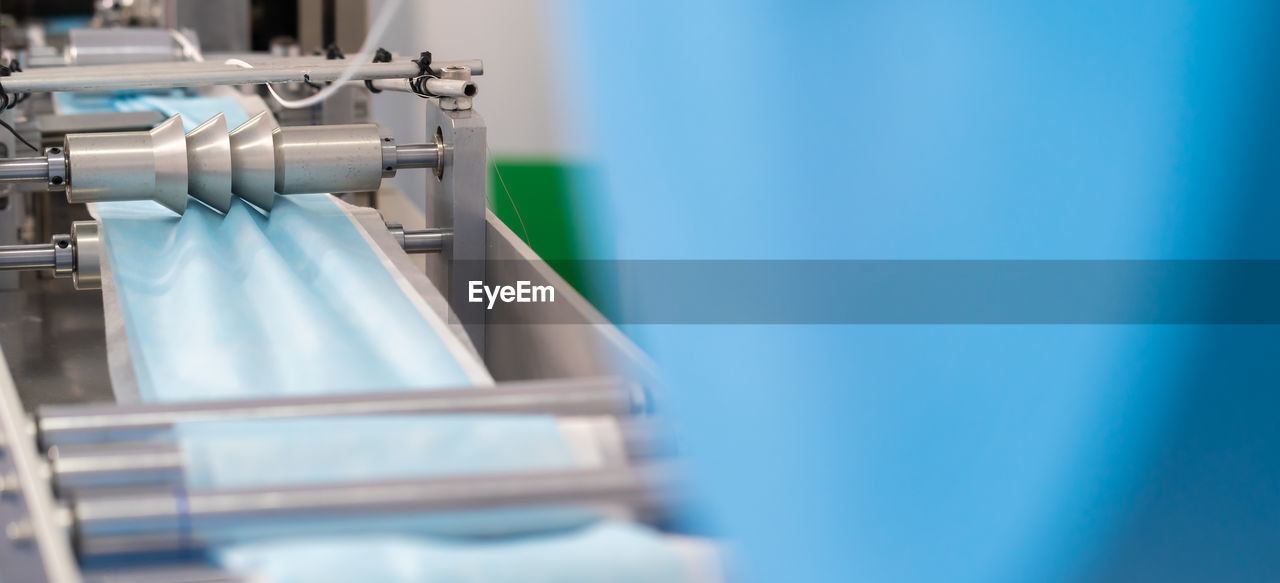 Close-up of surgical mask manufacturing in factory