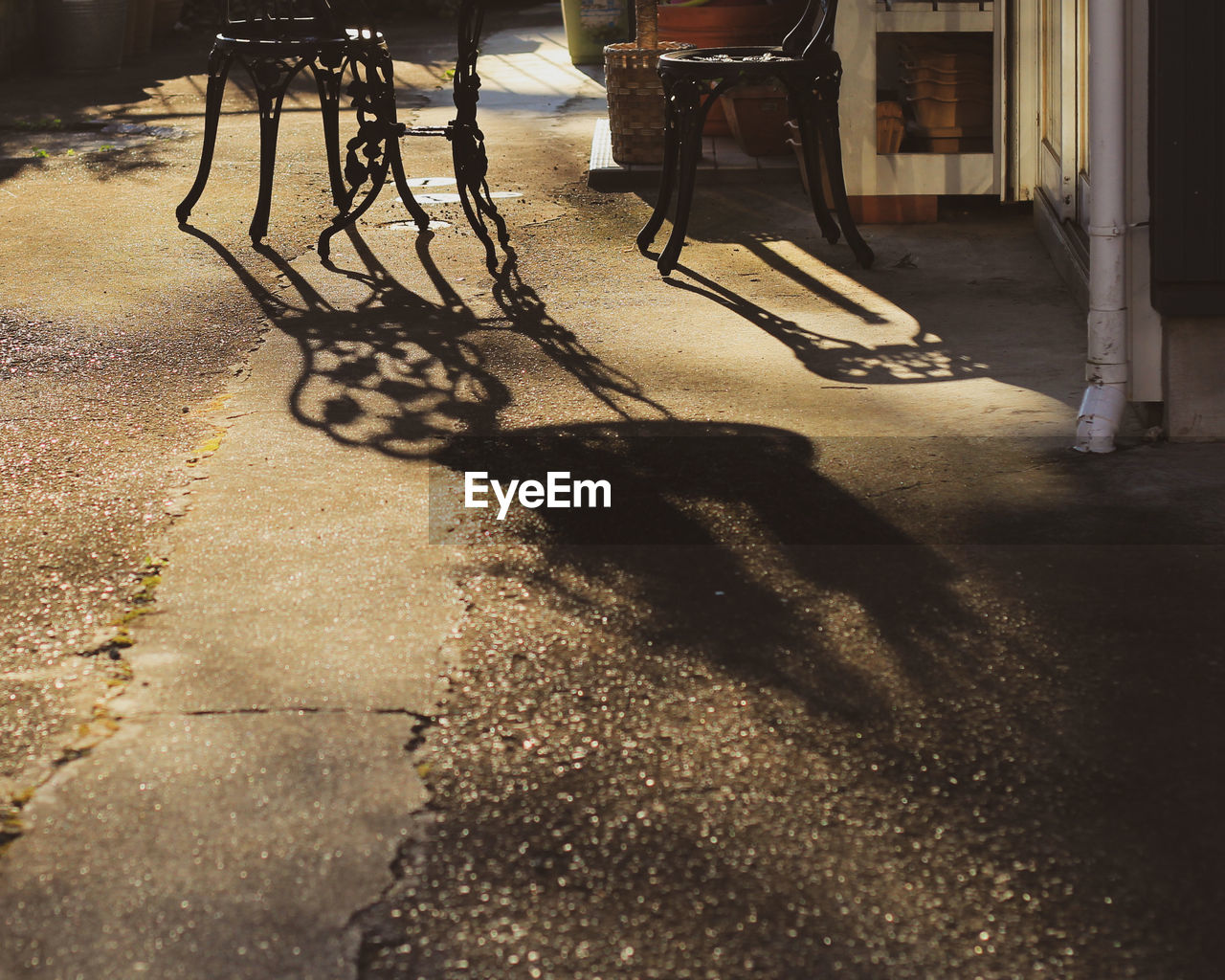 Table and chairs with shadow on road