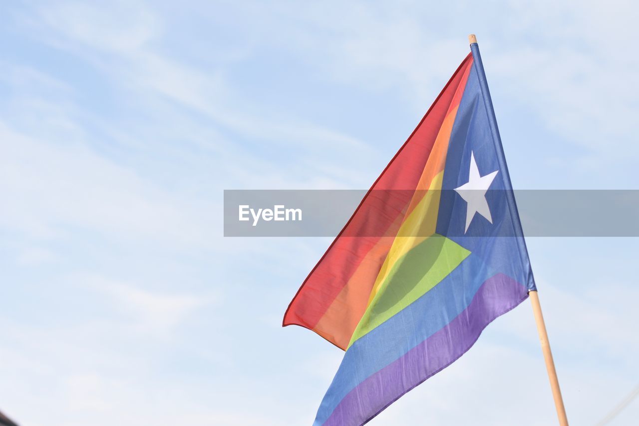 Low angle view of catalonian rainbow flag against sky