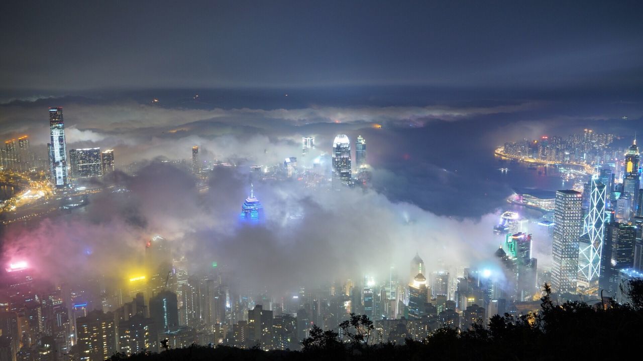 HIGH ANGLE VIEW OF ILLUMINATED CITY AT NIGHT