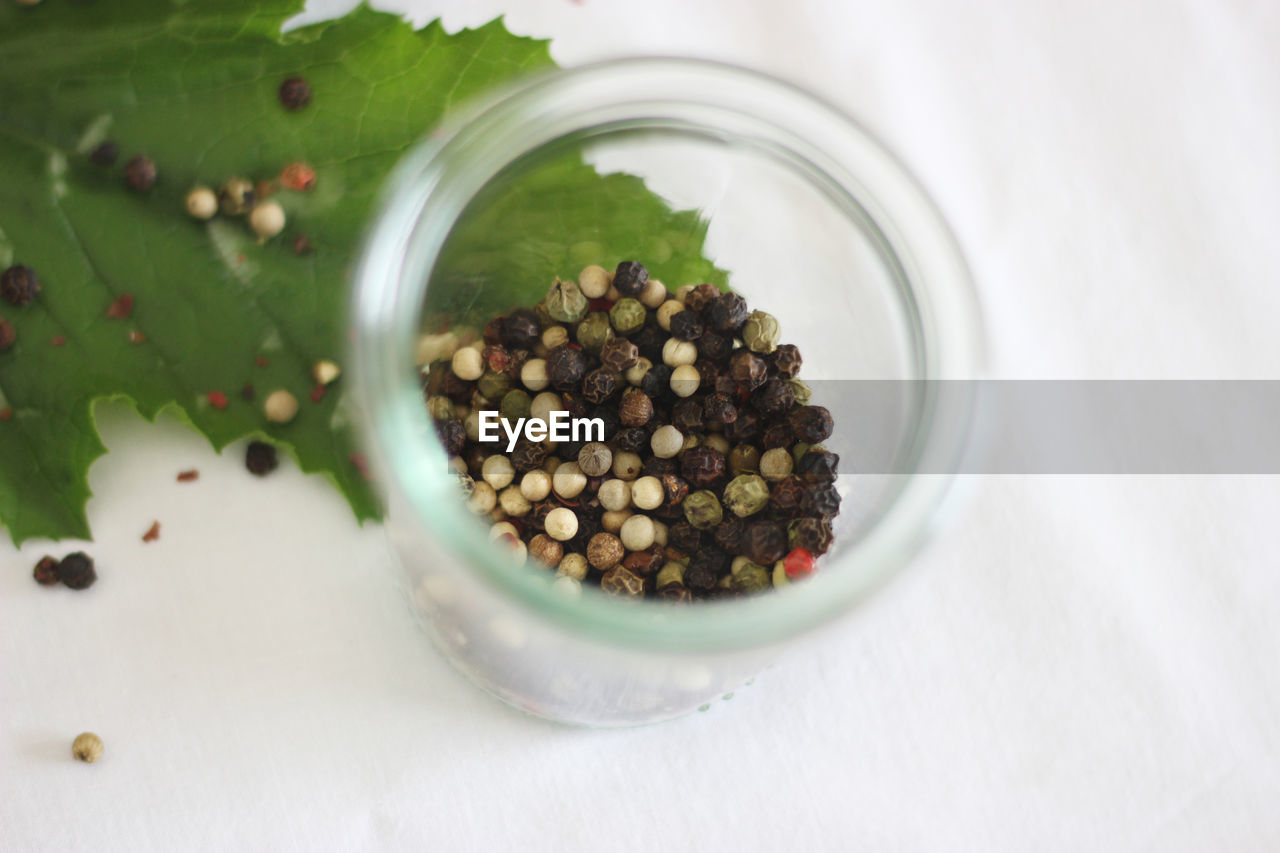 High angle view of peppercorns in jar