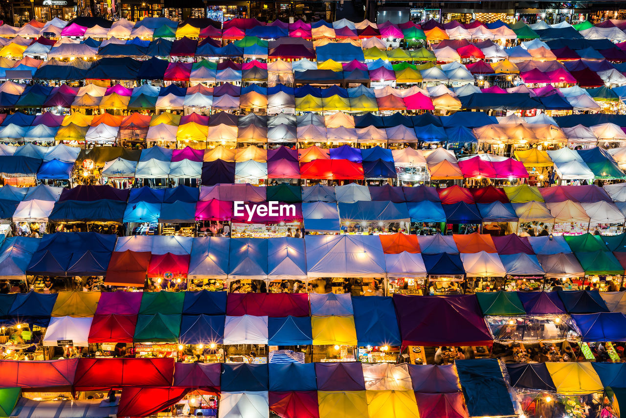 High angle view of colorful illuminated tents in market