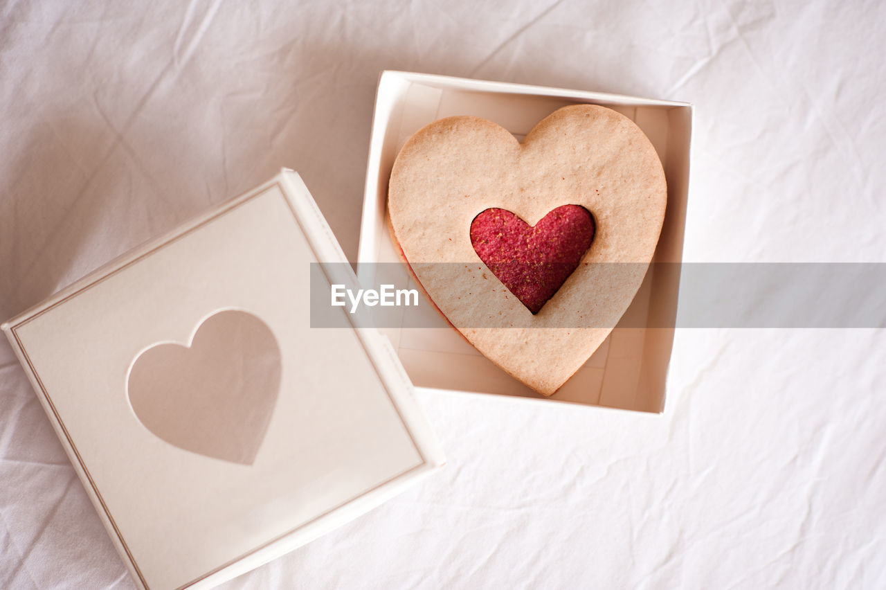 heart shape, love, heart, positive emotion, valentine's day, emotion, romance, food and drink, indoors, food, paper, cookie, baked, high angle view, sweet food, still life, wood, box, sweet, mother's day, copy space, shape, valentine card, celebration, greeting card, togetherness, table, human eye