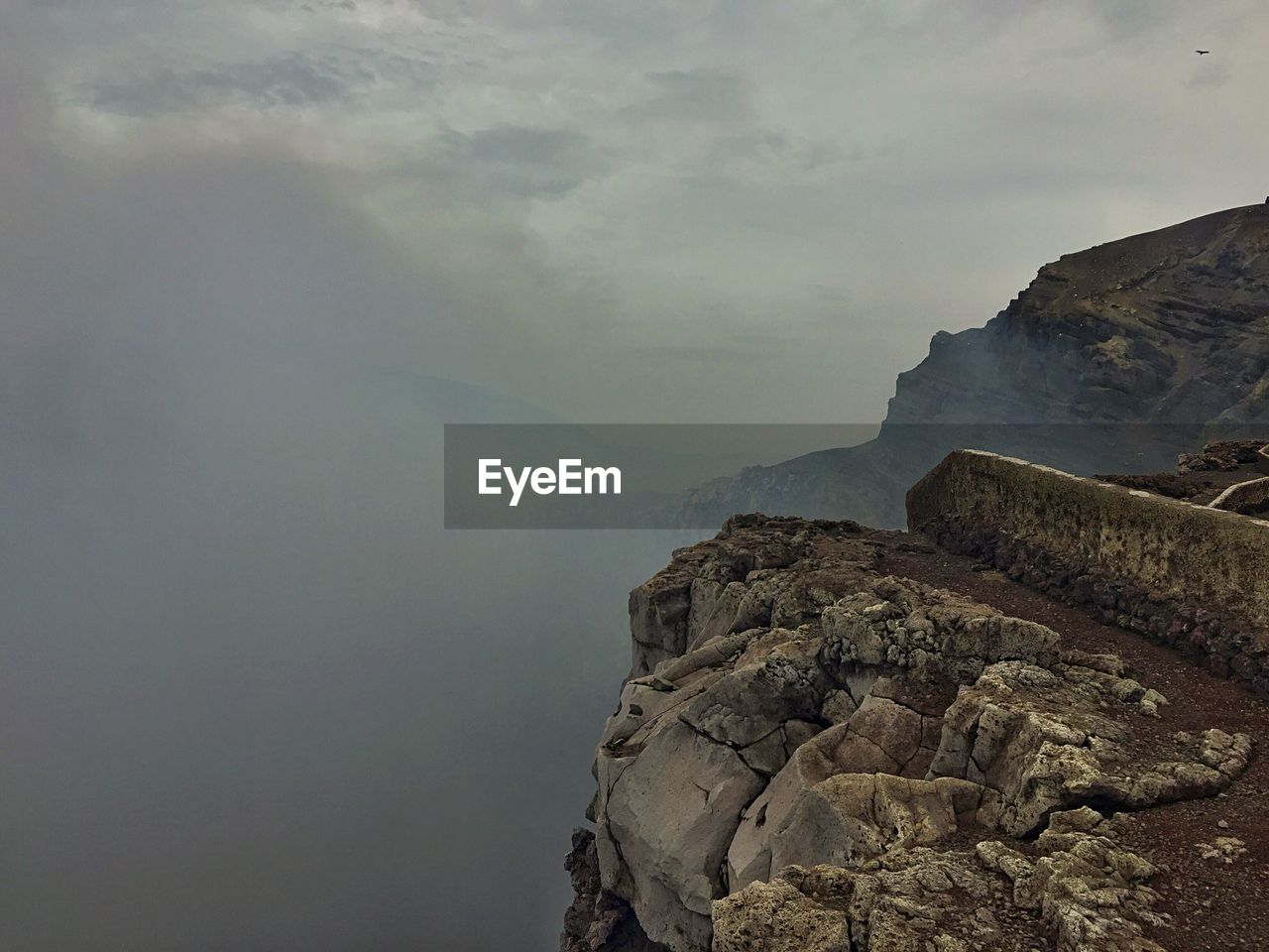 Scenic view of mountains against cloudy sky