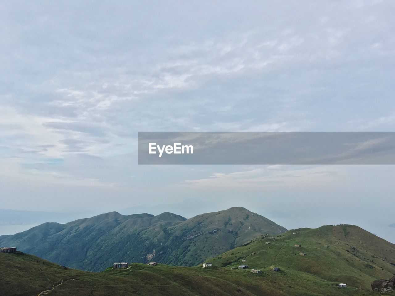 Countryside landscape against mountain range