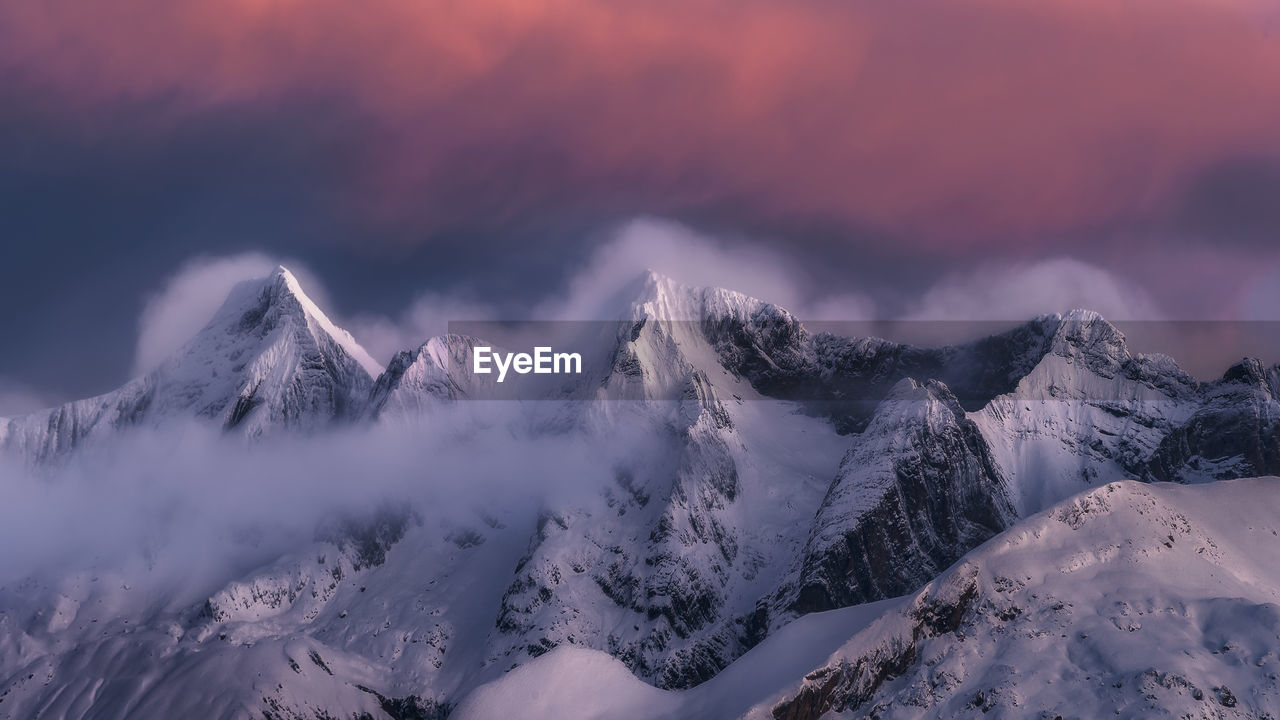 Landscape of snowy mountains covered by clouds. national park picos de europa, spain