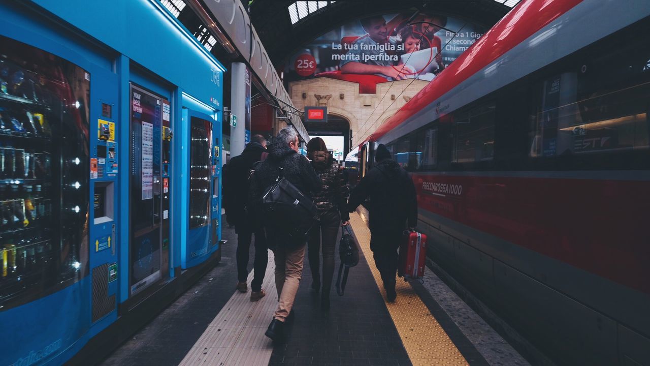 PEOPLE WAITING AT RAILROAD STATION