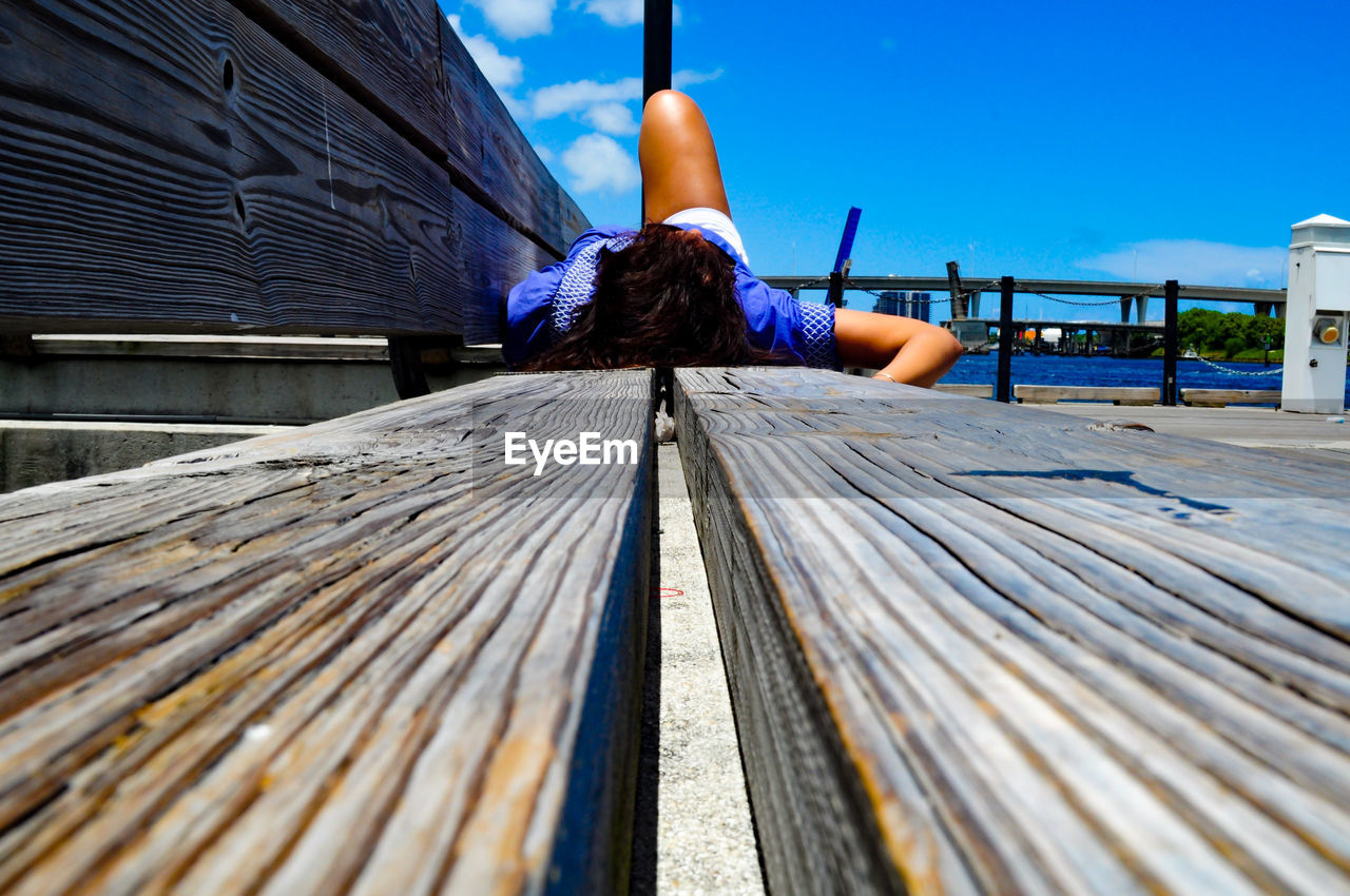 Rear view of woman relaxing on bench