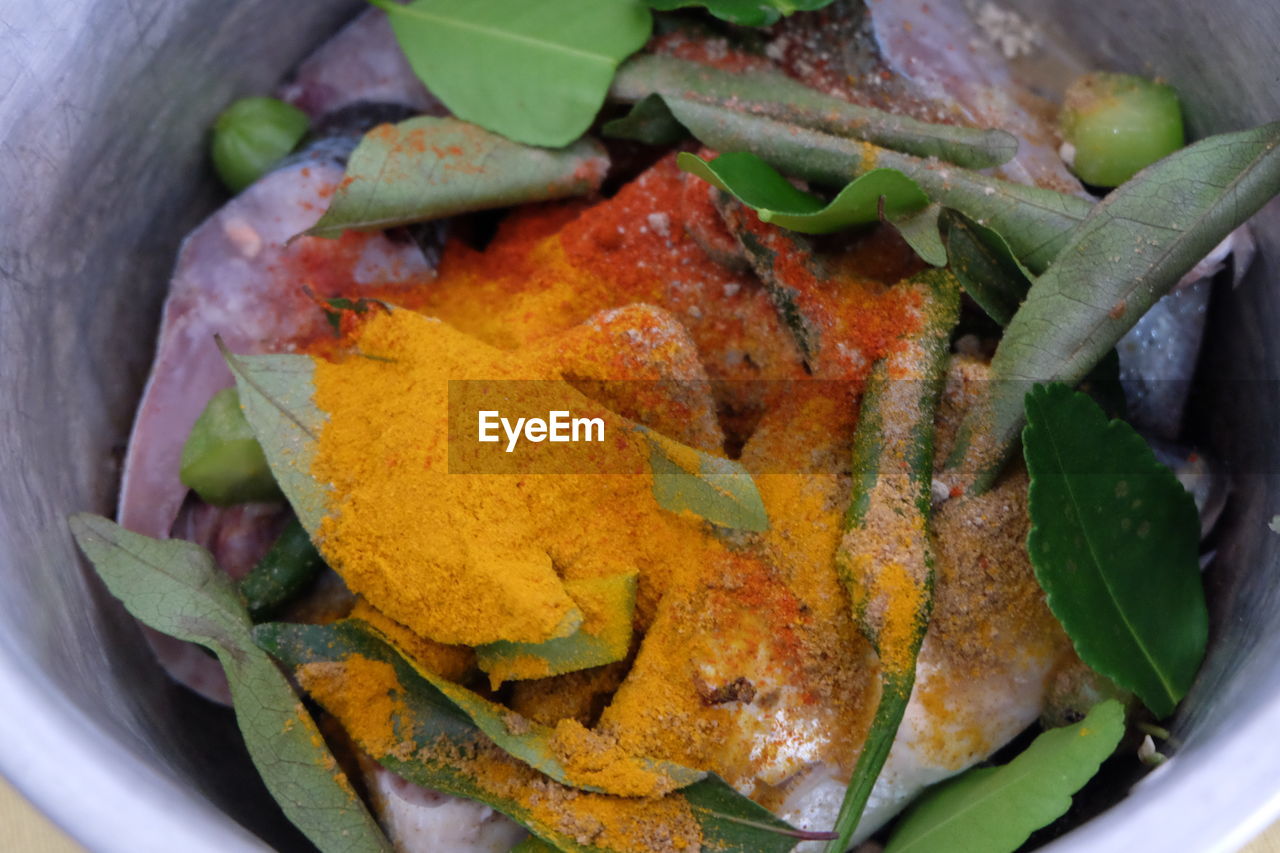 Close-up of turmeric on leaves in container