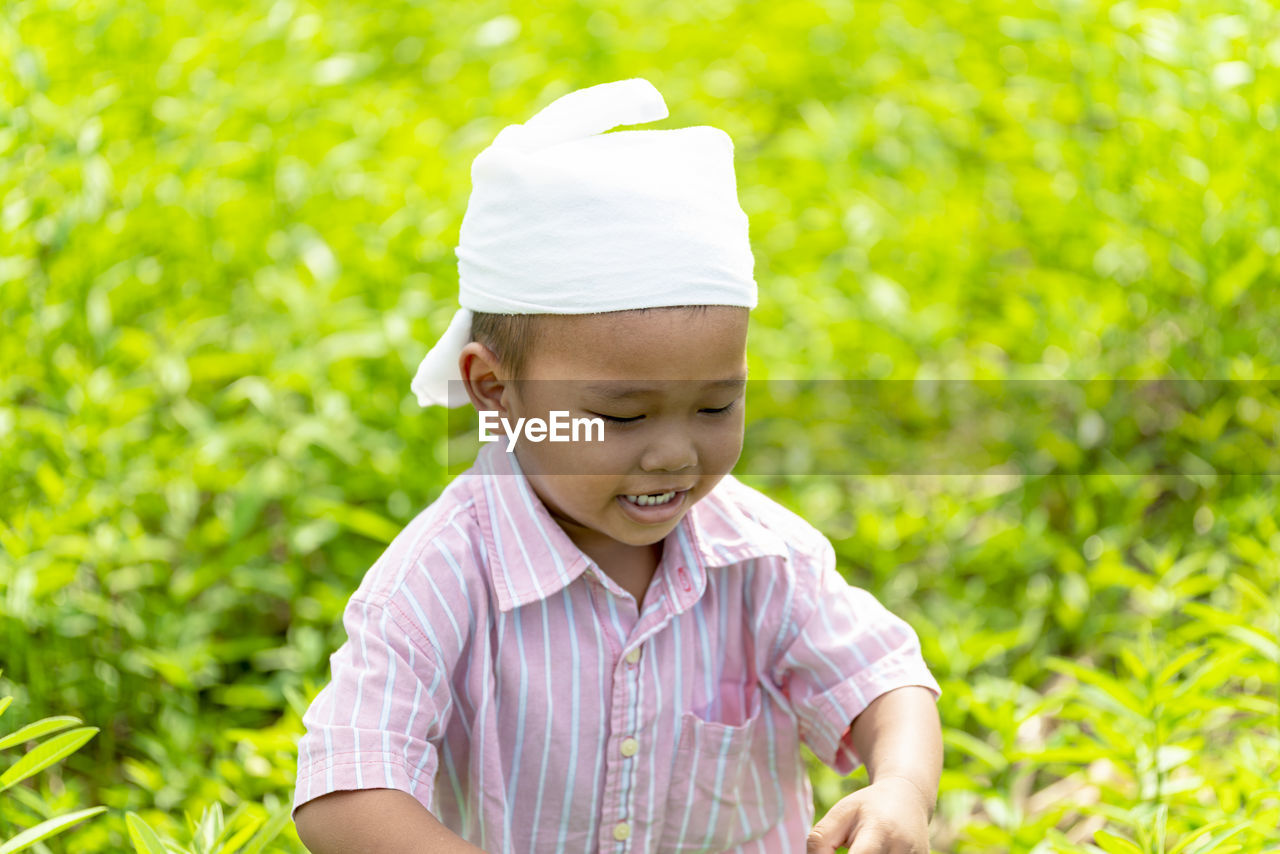 Smiling boy standing on field