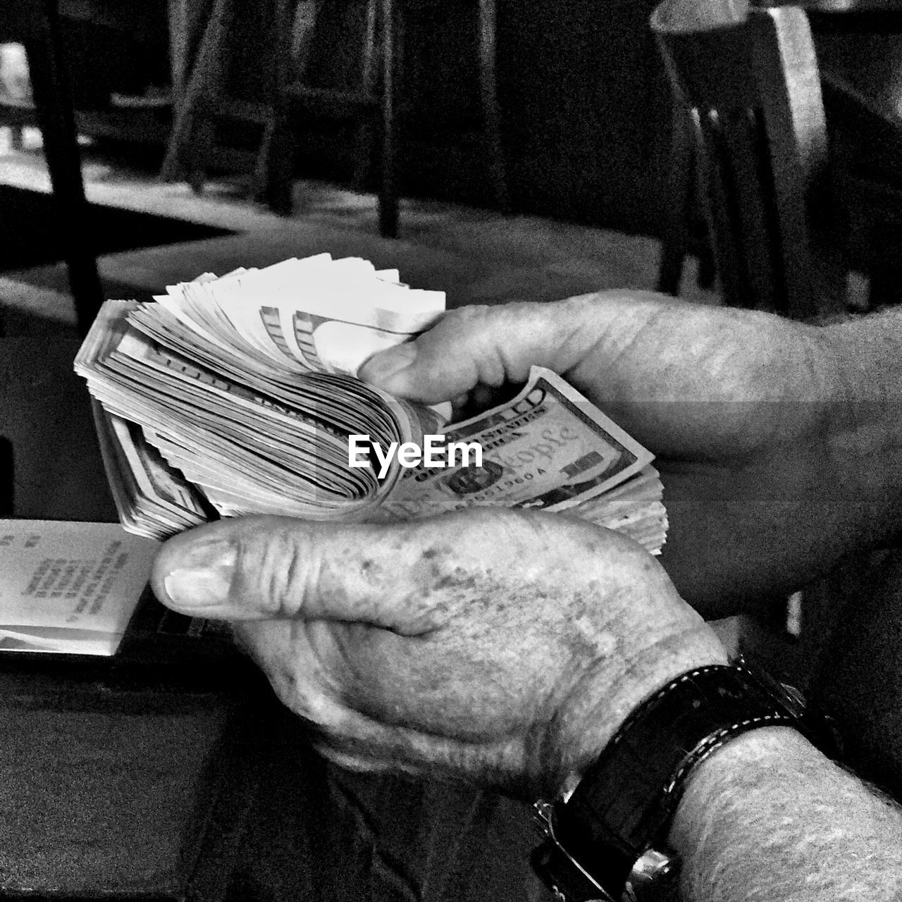 Close-up of man holding paper currency