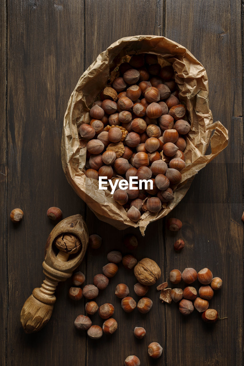 Autumn hazelnuts and walnuts on wooden table. top view.