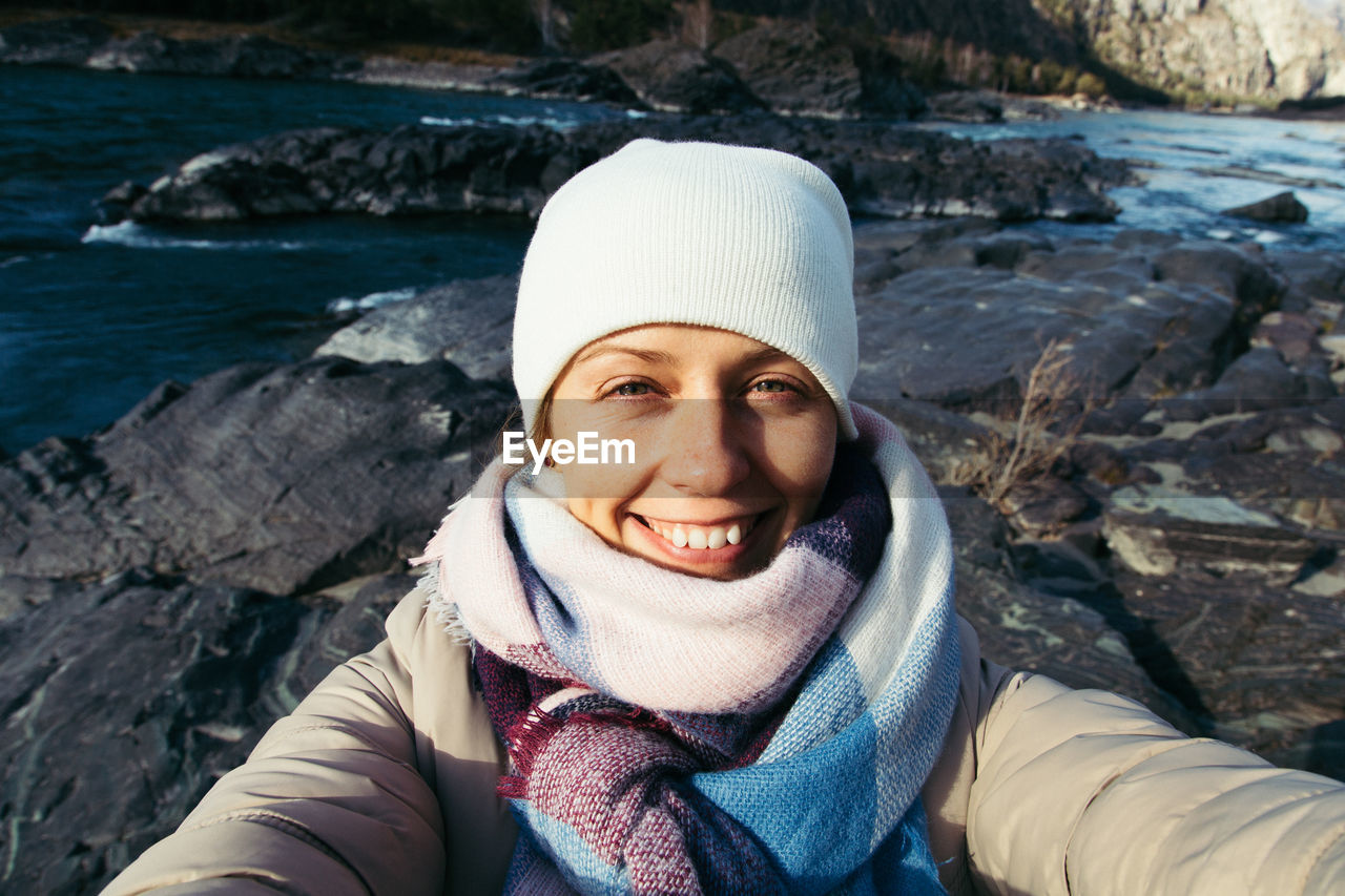 Portrait of young woman by river