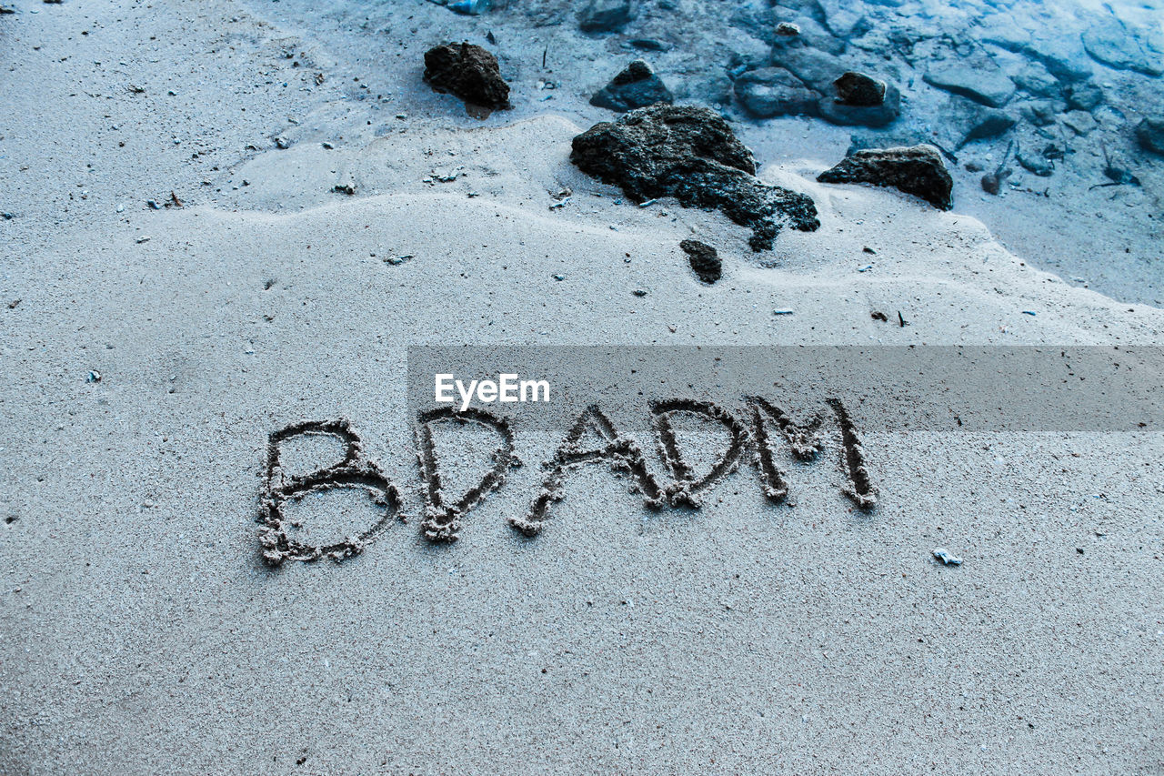 High angle view of text on sand at beach