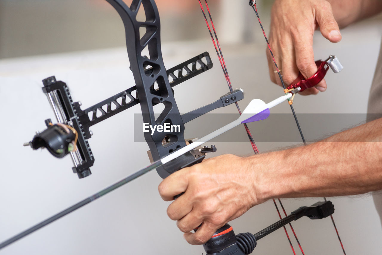 Close-up of man holding bow