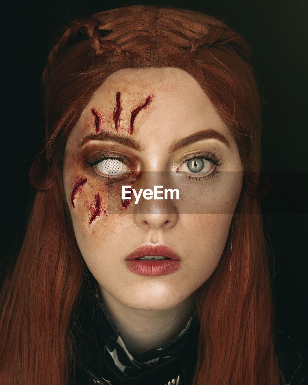 Digital composite image of woman with make-up against black background