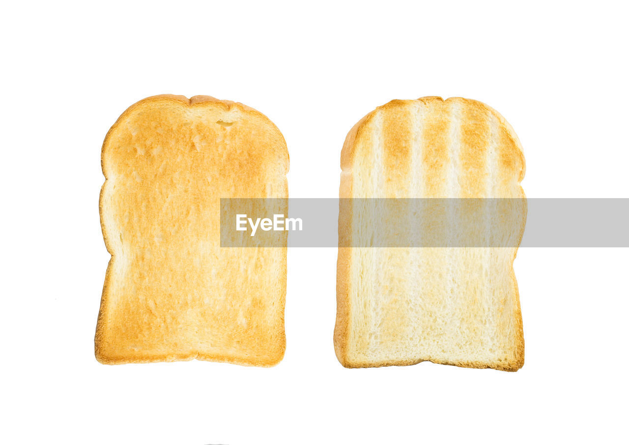 Close-up of toasted breads over white background