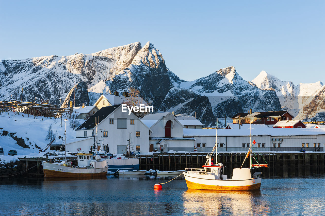 Fishing boat at small fishing harbor during winter, lofoten islands, norway.