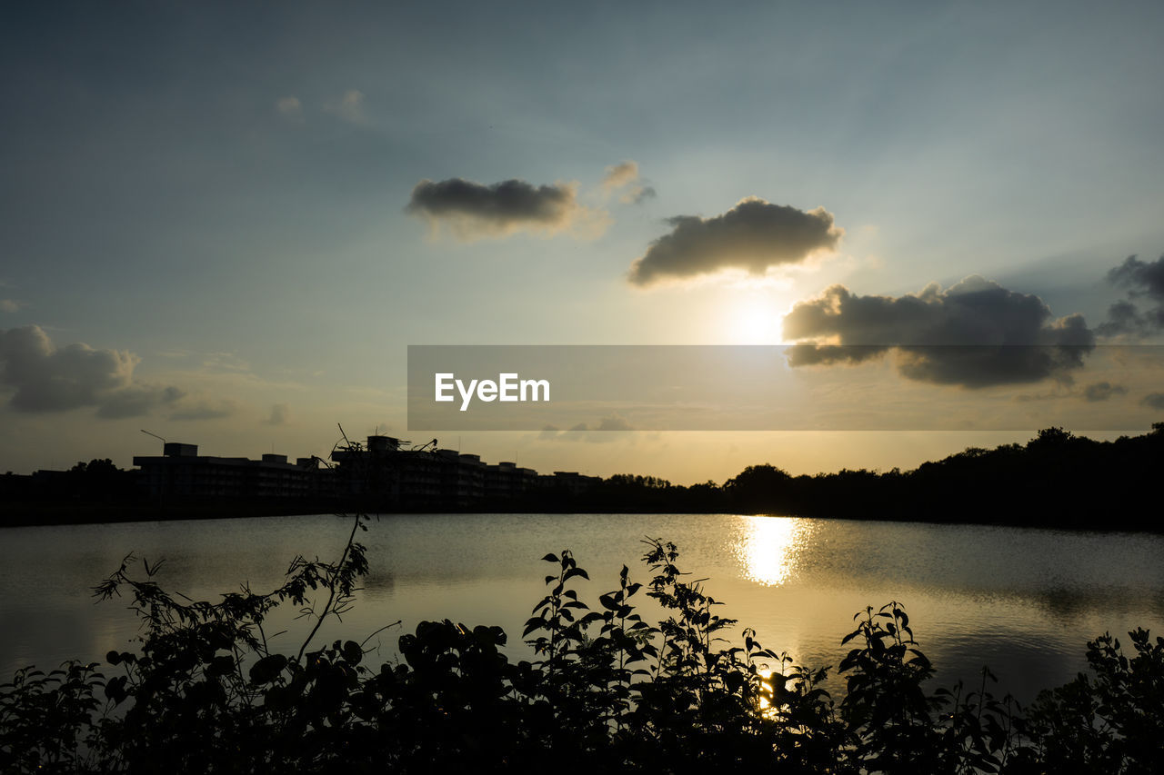 SCENIC VIEW OF LAKE BY SILHOUETTE TREES AGAINST SKY