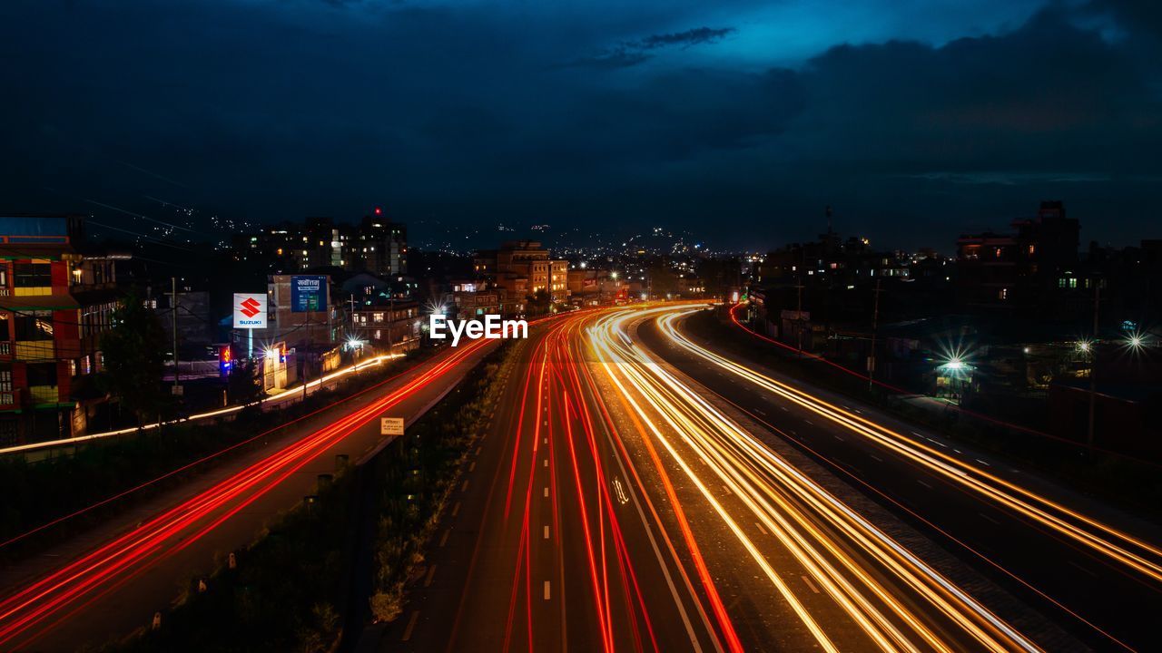 High angle view of light trails on road at night