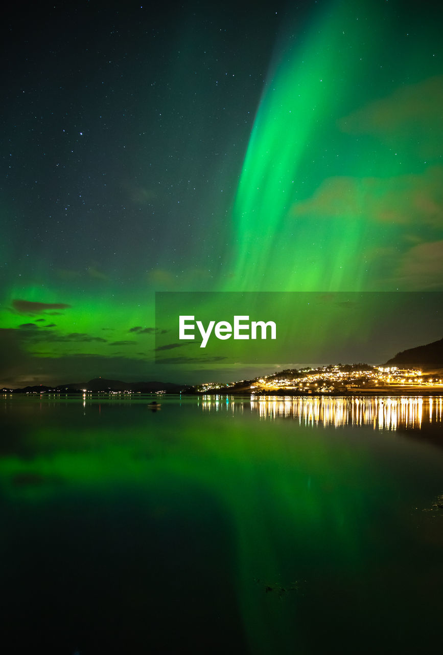 Scenic view of lake against aurora borealis at night