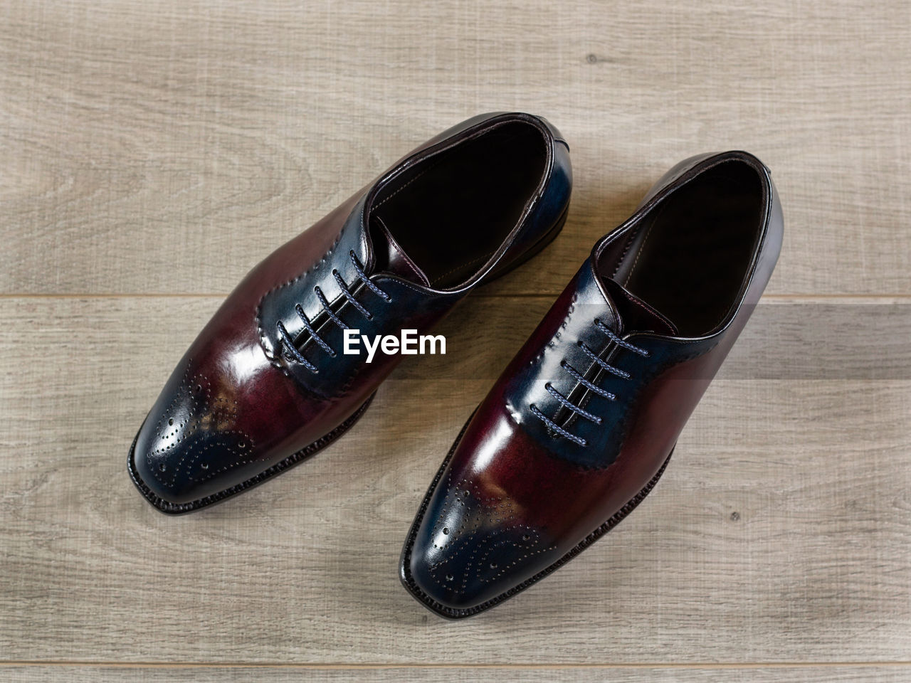 Polished leather brogues. perforated men's shoes, close-up, on a wooden surface