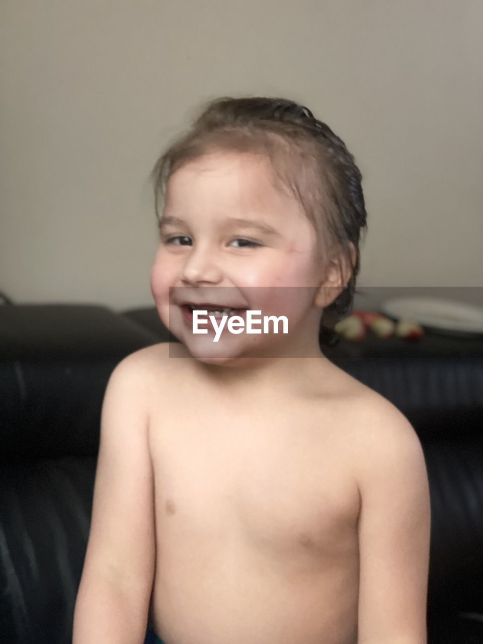 PORTRAIT OF CUTE BOY SMILING AT HOME