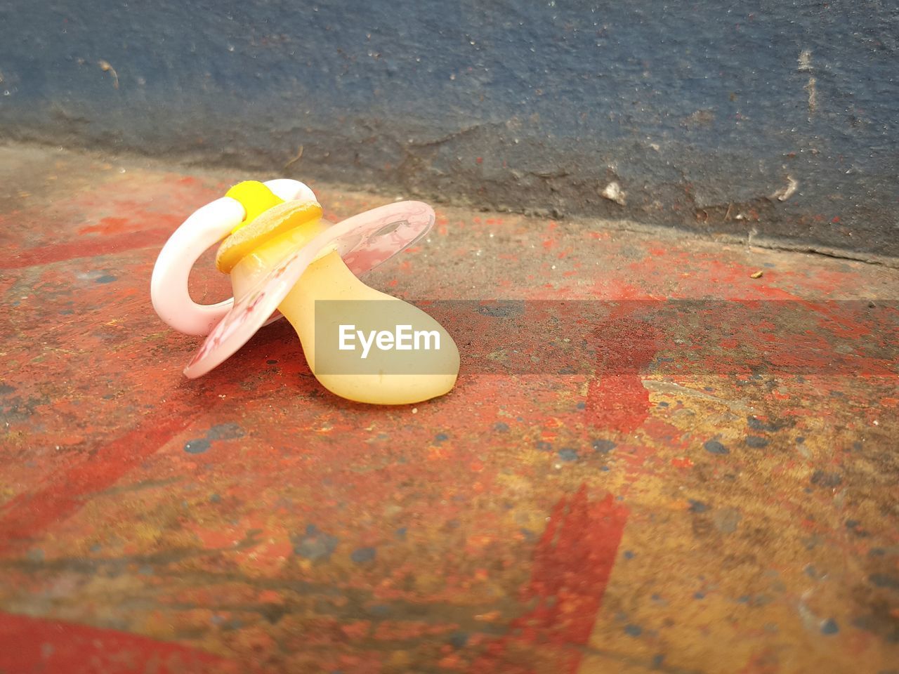 Close-up of lost pacifier on ground