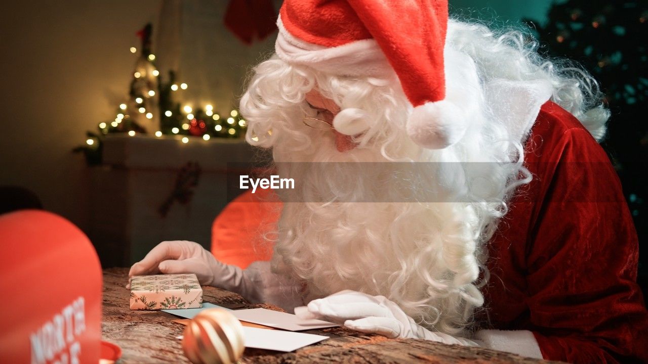 rear view of girl playing with christmas tree at home