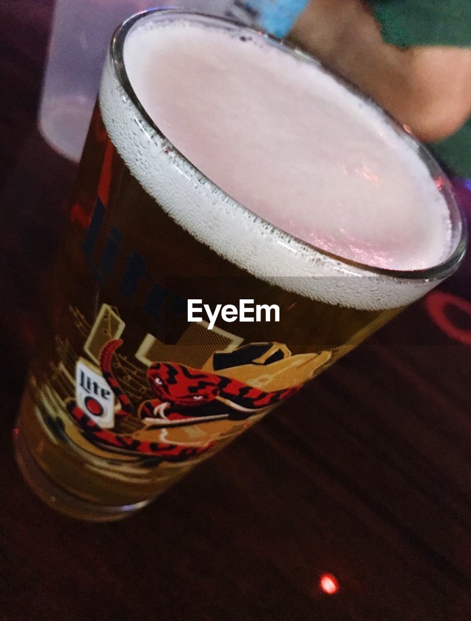 CLOSE-UP OF BEER GLASS ON BAR