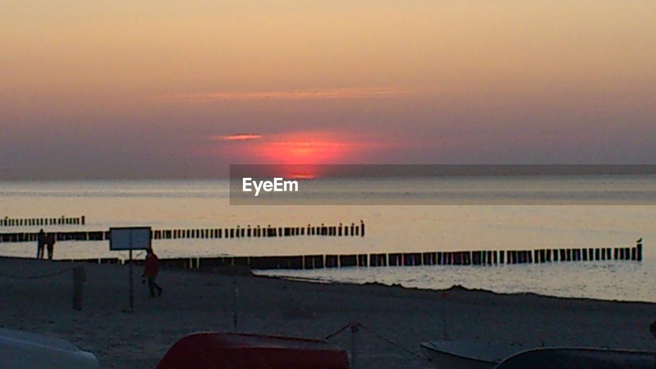 SCENIC VIEW OF SUNSET OVER SEA