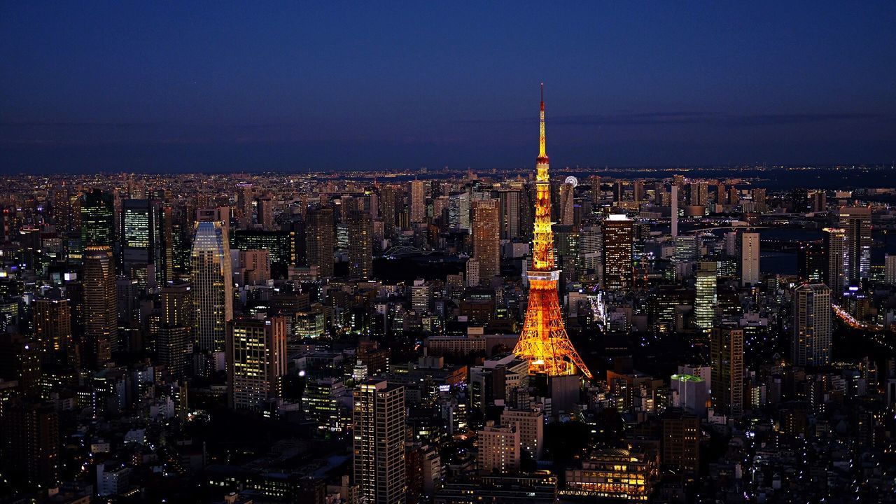 Illuminated cityscape against sky at night