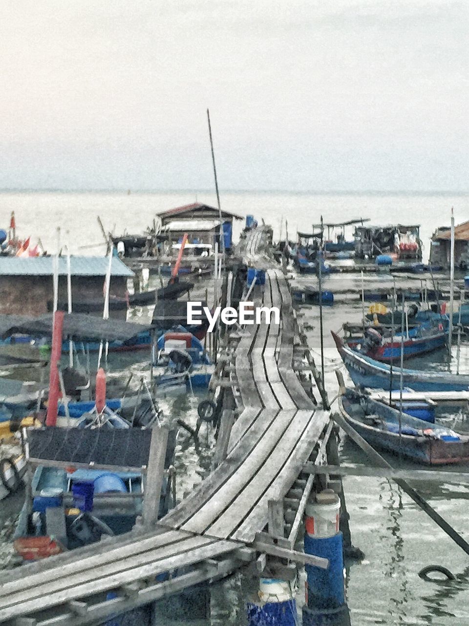 BOATS MOORED IN HARBOR