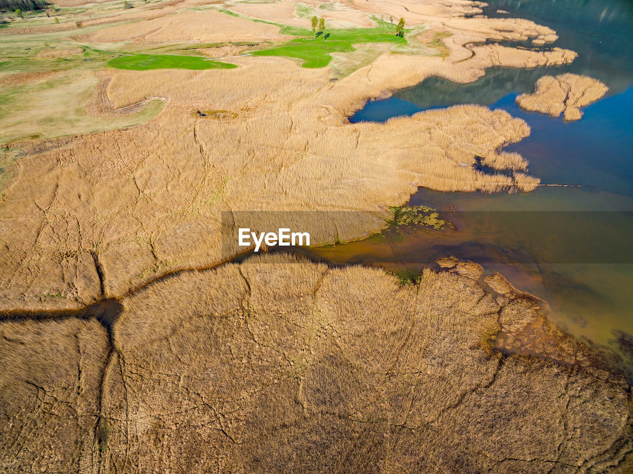 HIGH ANGLE VIEW OF CRACKED LANDSCAPE