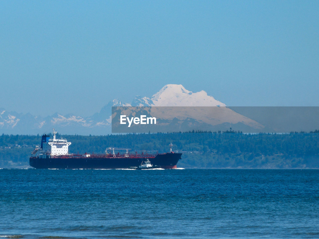 Ship sailing on sea against sky