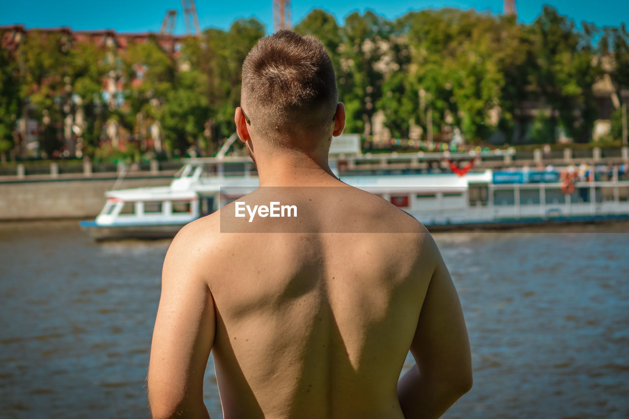 Rear view of shirtless boy in swimming pool