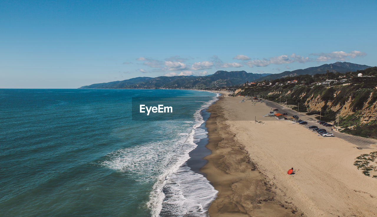 Panoramic view of beach against clear blue sky