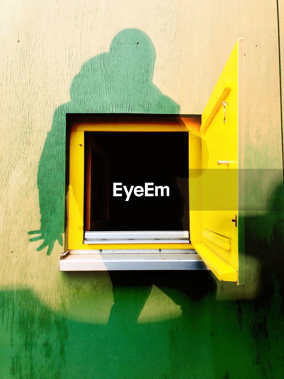 Close-up of yellow window on building