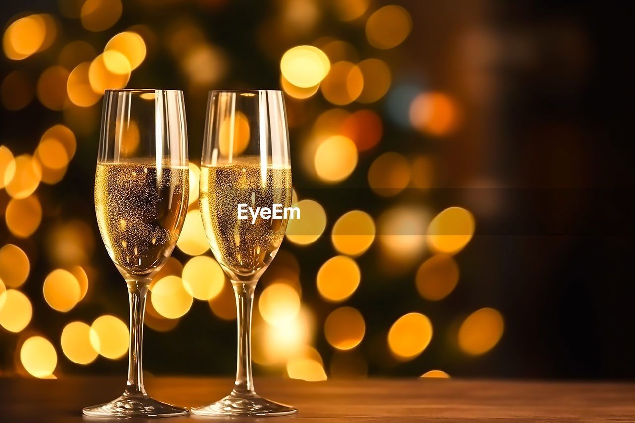 Two misted glasses of champagne on the background of a festive christmas bokeh.