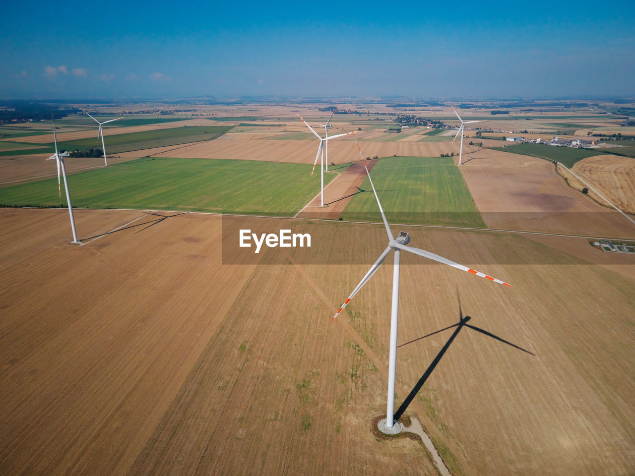 Aerial view of wind turbine in countryside area, wind power plants in agricultural field