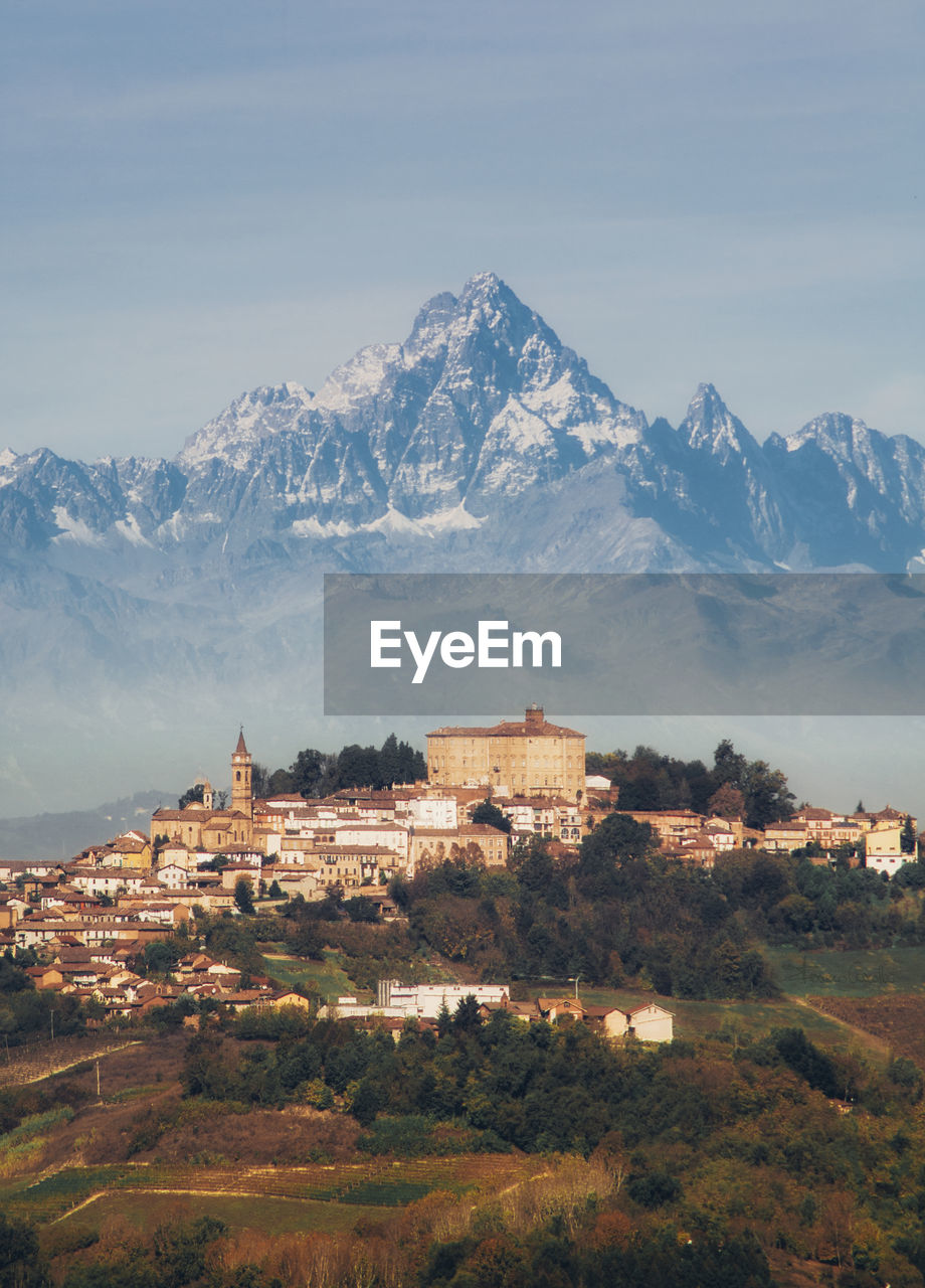 Buildings and mountains against sky