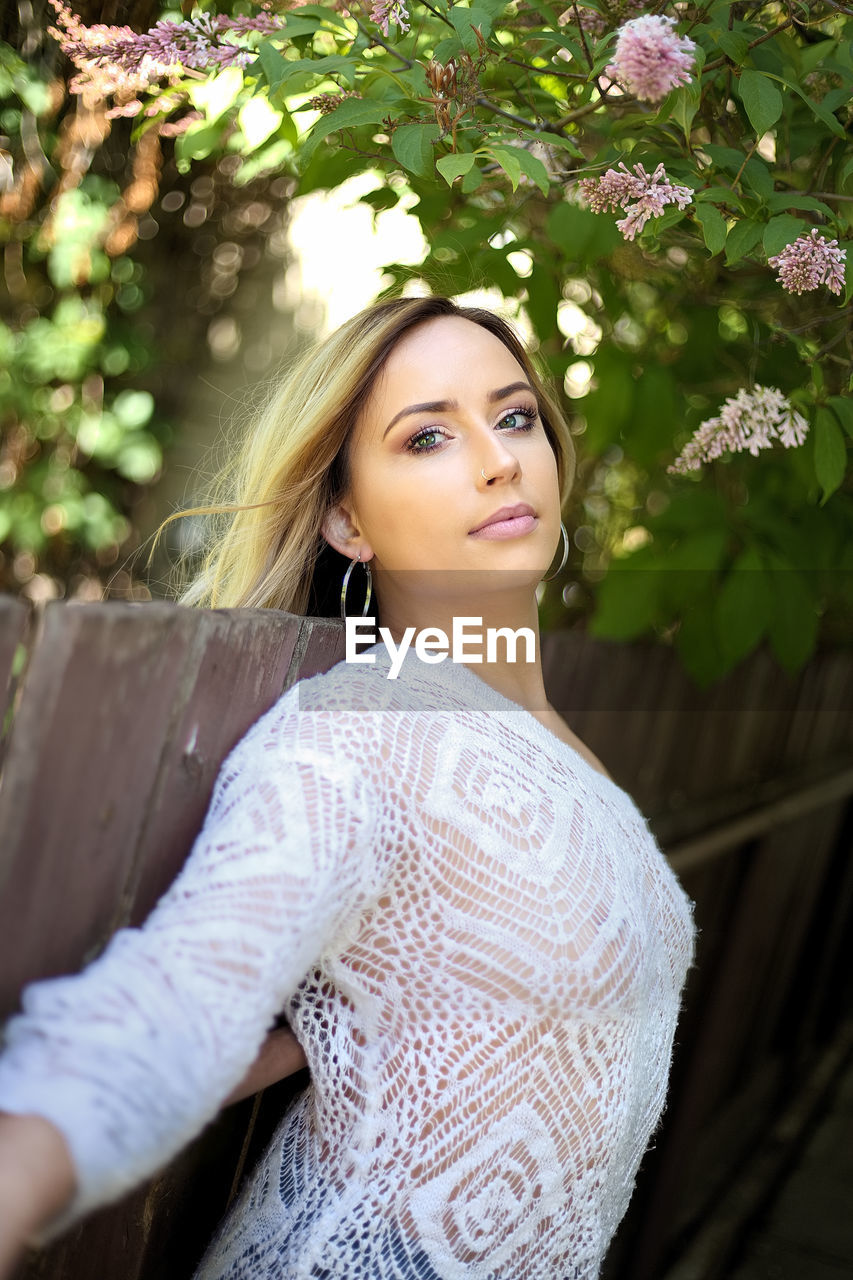 Portrait of beautiful woman standing in park