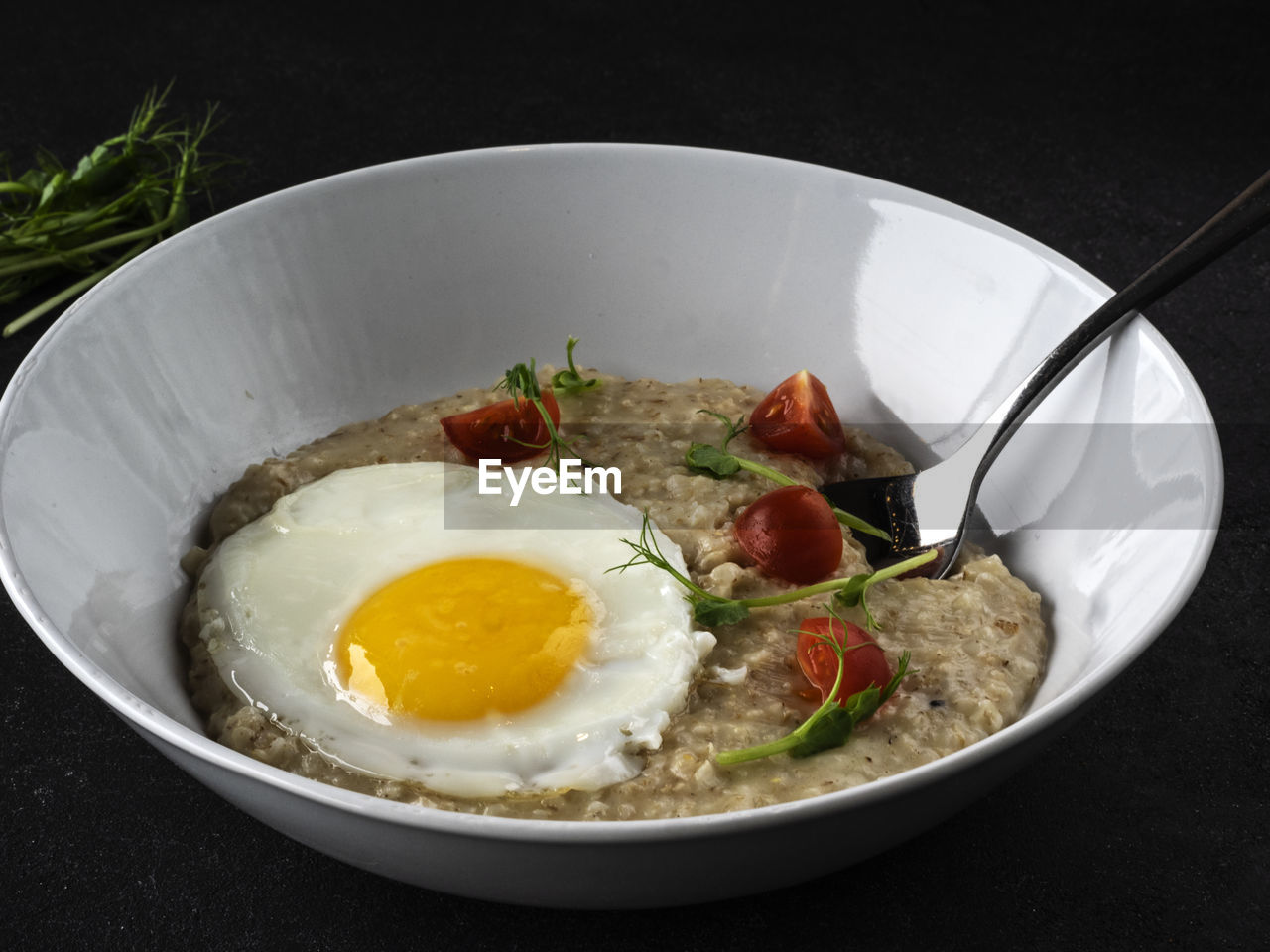 Parmesan oatmeal and scrambled eggs on the table