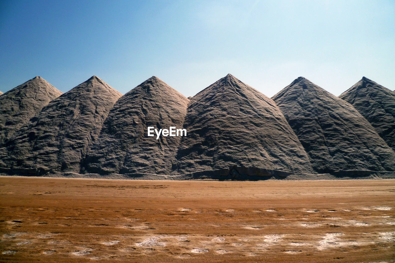 Built structure on land against clear blue sky