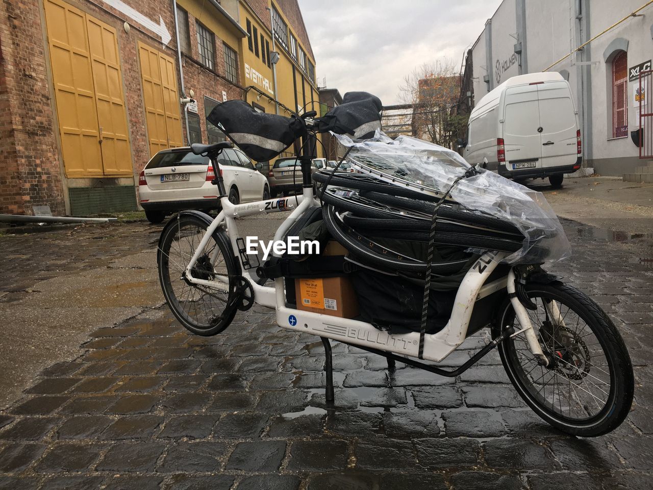 BICYCLE PARKED ON STREET AGAINST BUILDINGS